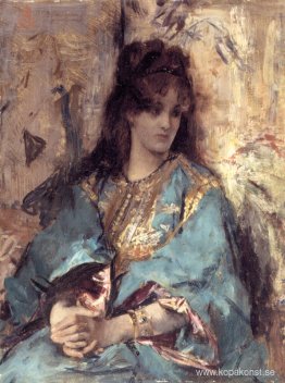 En kvinna som sitter i orientalisk klänning En kvinna som sitter i orientalisk klänning