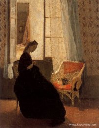 Kvinna som syr vid ett fönster