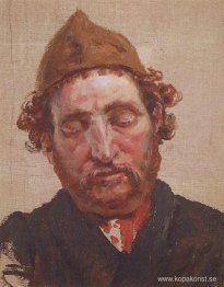 Huvud av rödhårig man med gul mössa