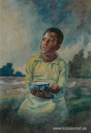 Ung pojke med en skål och sked