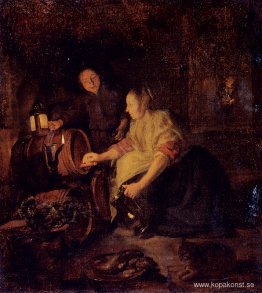 En kvinna som drar vin från en fat En kvinna som drar vin från en fat