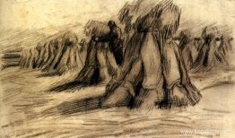 Stooks och en bonde som staplar kärvar Stooks och en bonde som staplar kärvar